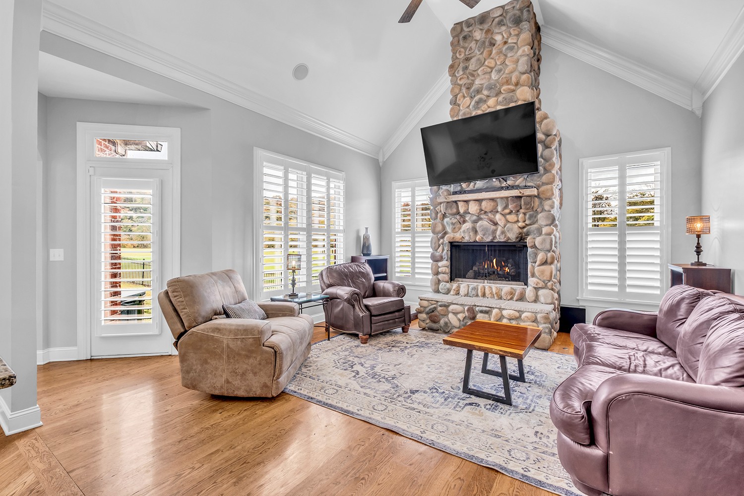 5210 Old Harding Road Franklin, TN 37064 - Photo 25 of 65 a living room with furniture a fireplace and a flat screen tv
