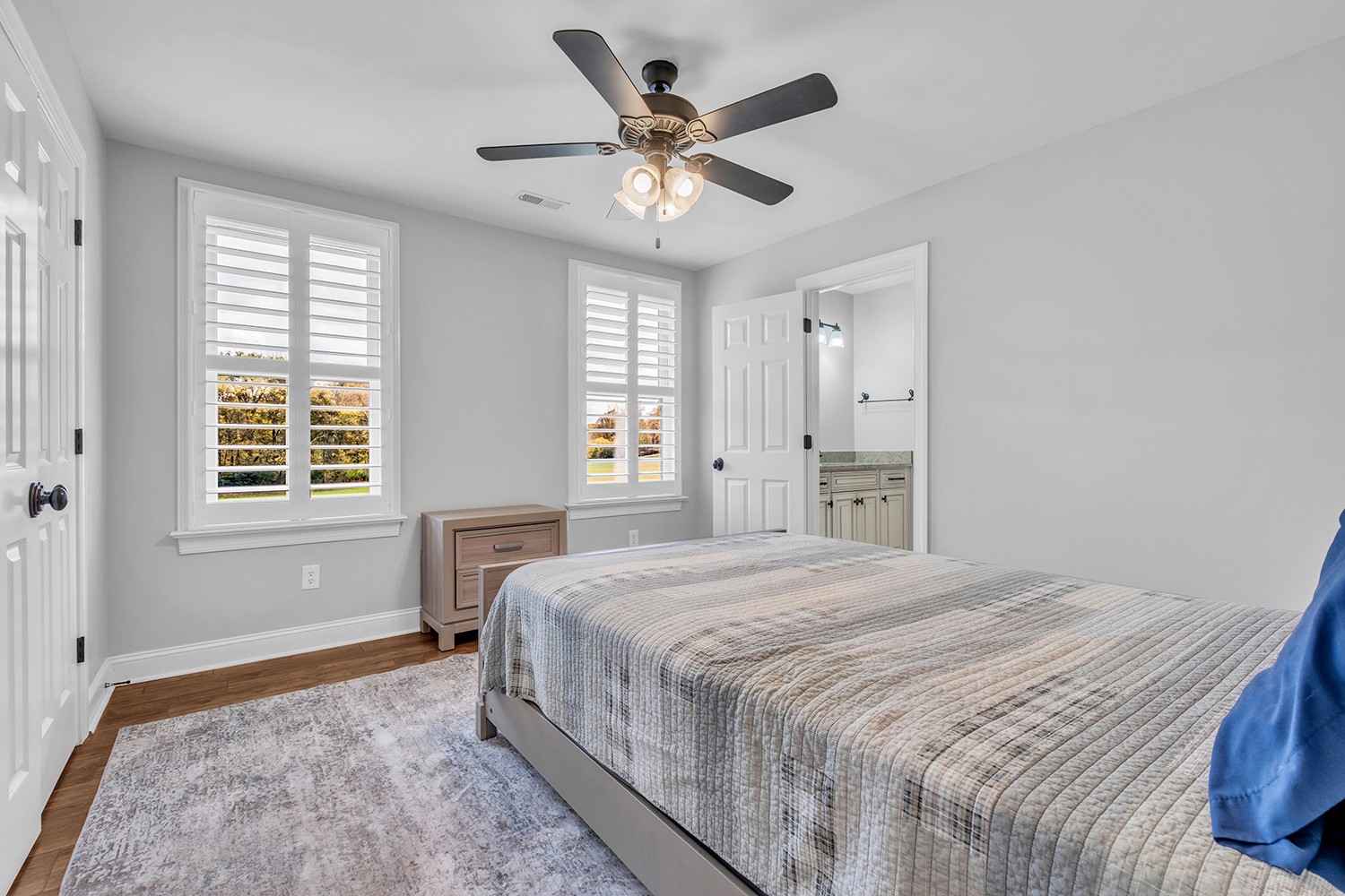 5210 Old Harding Road Franklin, TN 37064 - Photo 38 of 65 a bedroom with a large bed and a chandelier