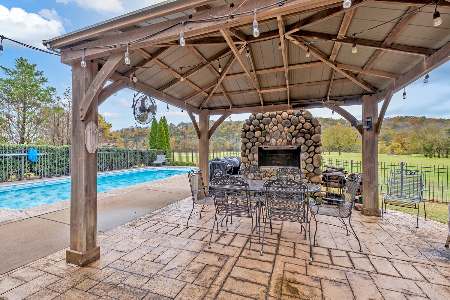 5210 Old Harding Road Franklin, TN 37064 - Photo 46 of 65 a view of a patio with a table and chairs under an umbrella