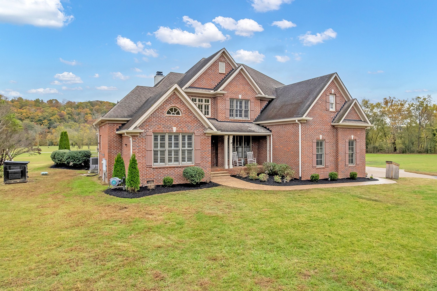 5210 Old Harding Road Franklin, TN 37064 - Photo 5 of 65 a front view of a house with a garden and yard