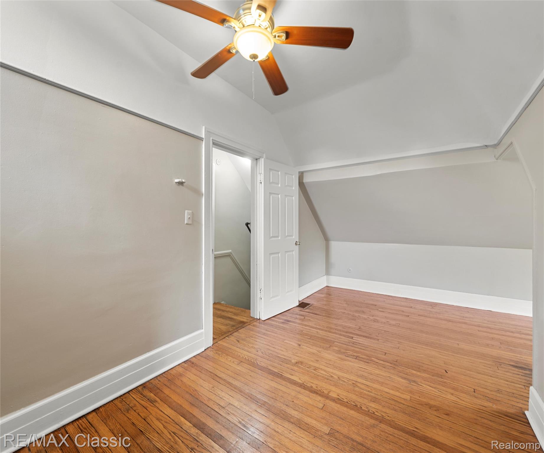 3941 Trumbull Detroit, MI 48208 - Photo 10 of 46 Room featuring wood-finish flooring, a ceiling fan with integrated lighting, and sloped ceilings