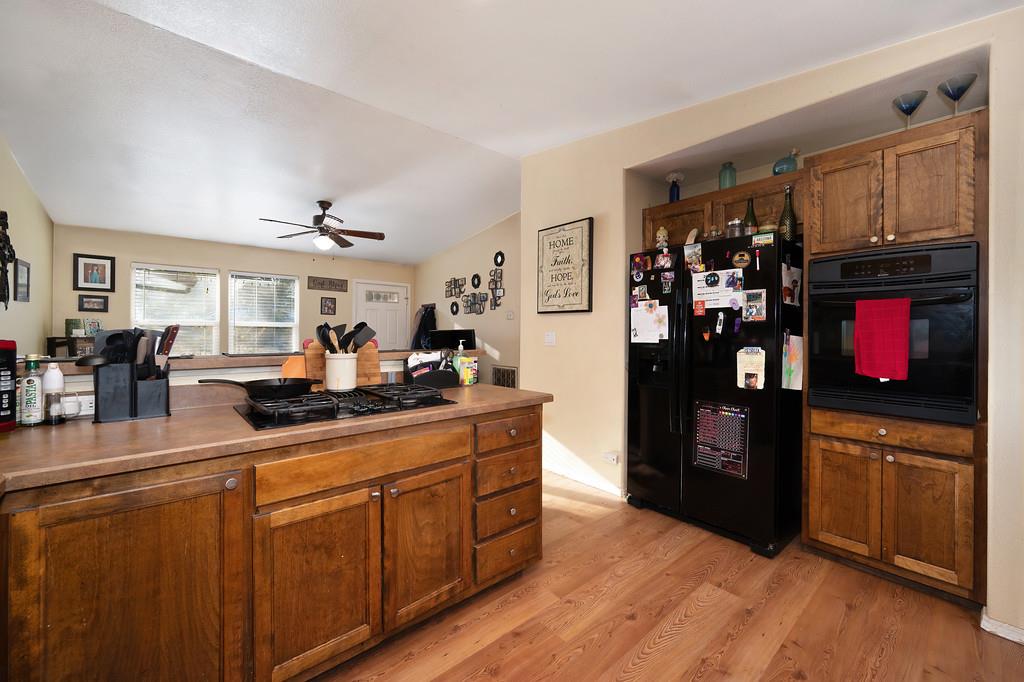11425 Joeger Road Auburn, CA 95602 - Photo 11 of 52 a kitchen with stainless steel appliances granite countertop a refrigerator and a stove top oven