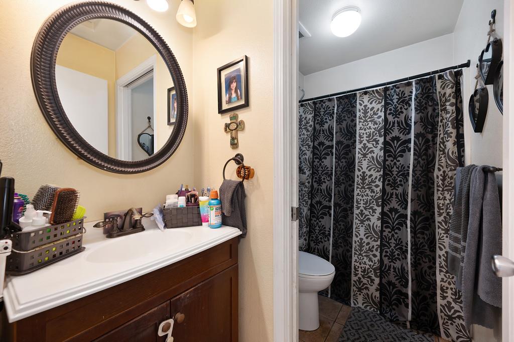 11425 Joeger Road Auburn, CA 95602 - Photo 14 of 52 a bathroom with a sink a toilet and a mirror