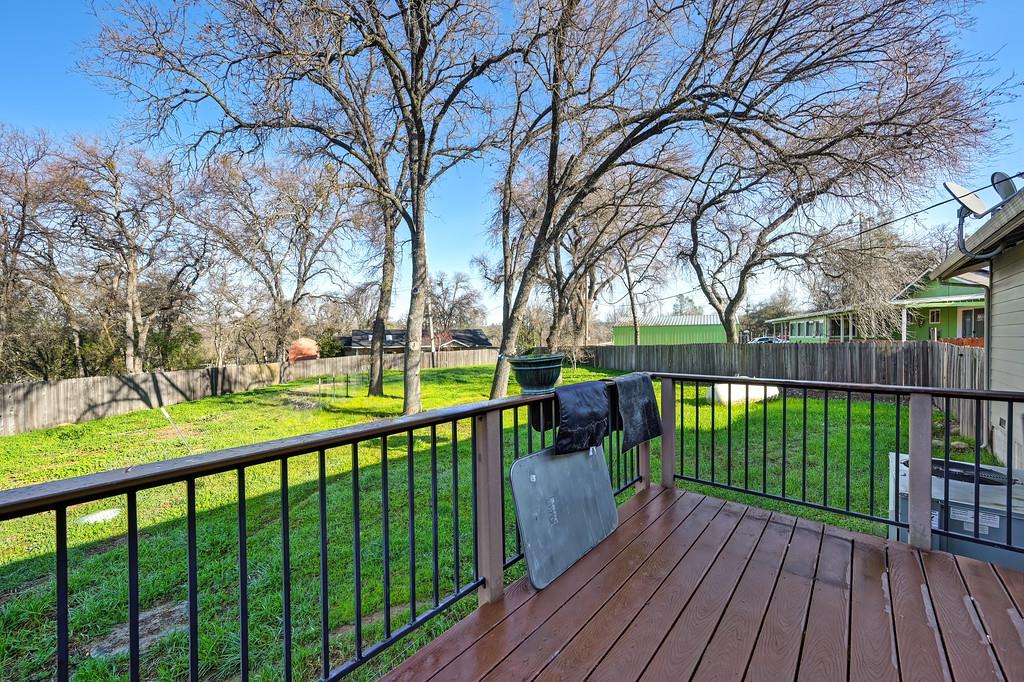 11425 Joeger Road Auburn, CA 95602 - Photo 16 of 52 a view of a deck with large trees and wooden fence