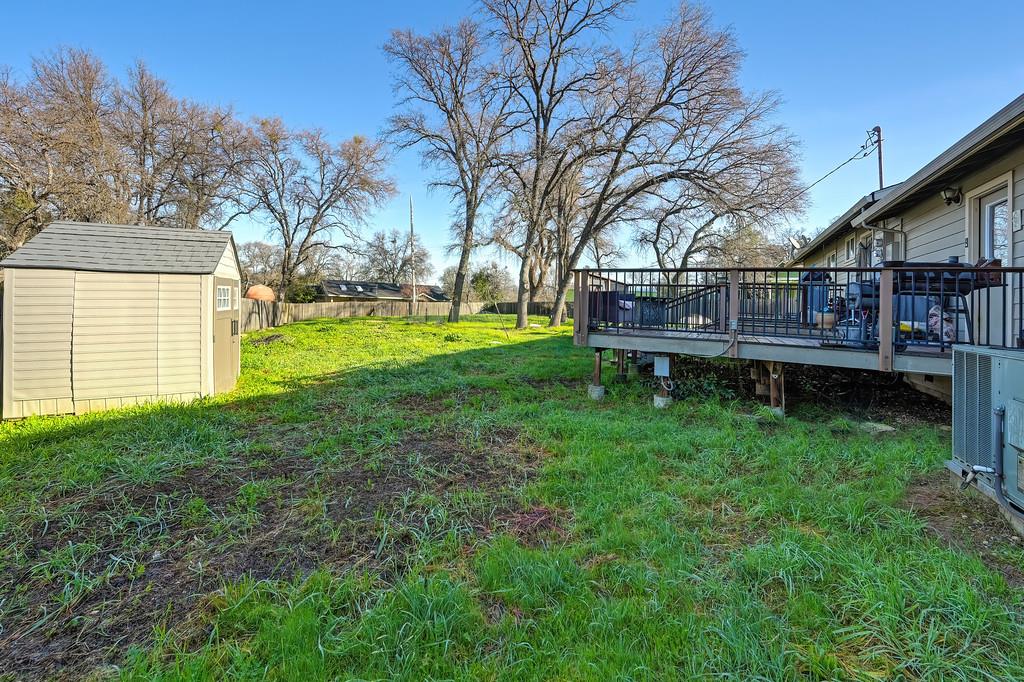 11425 Joeger Road Auburn, CA 95602 - Photo 18 of 52 a view of a house with a backyard and a patio