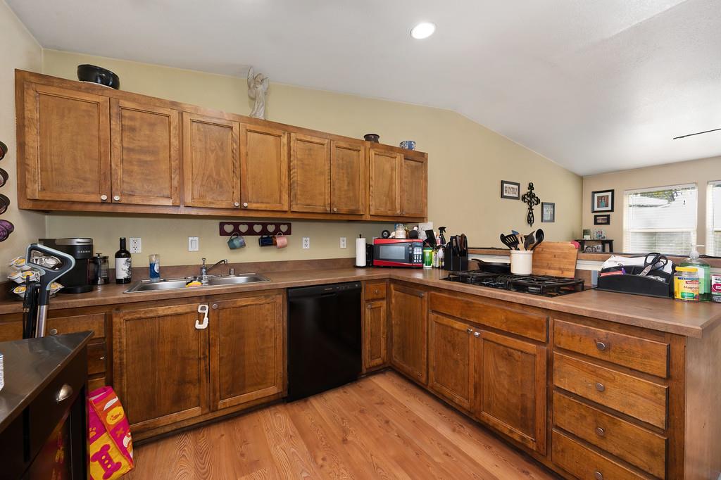 11425 Joeger Road Auburn, CA 95602 - Photo 10 of 52 a kitchen with kitchen island granite countertop a sink dishwasher stove and cabinets with wooden floor