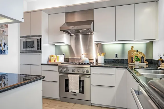 a kitchen with stainless steel appliances granite countertop a stove and a sink