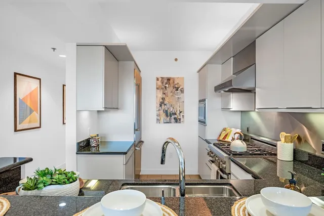 a bathroom with a sink mirror and vanity