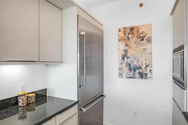 a kitchen with stainless steel appliances granite countertop a refrigerator and a stove