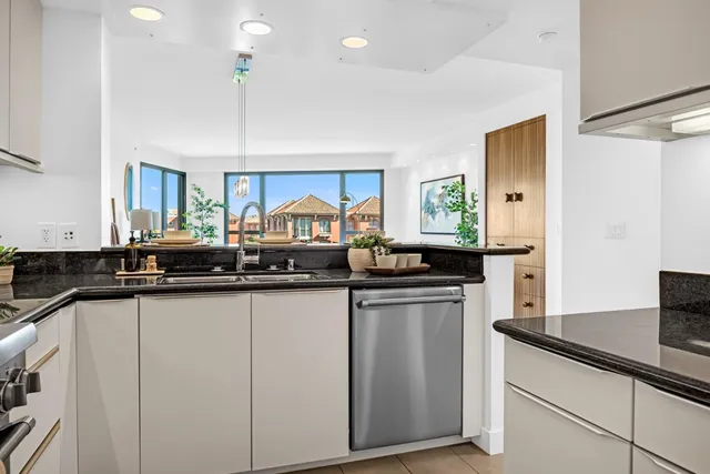 a kitchen with granite countertop a sink and cabinets