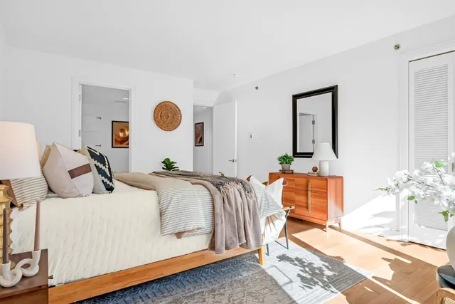 a bed room with a bed and a mirror