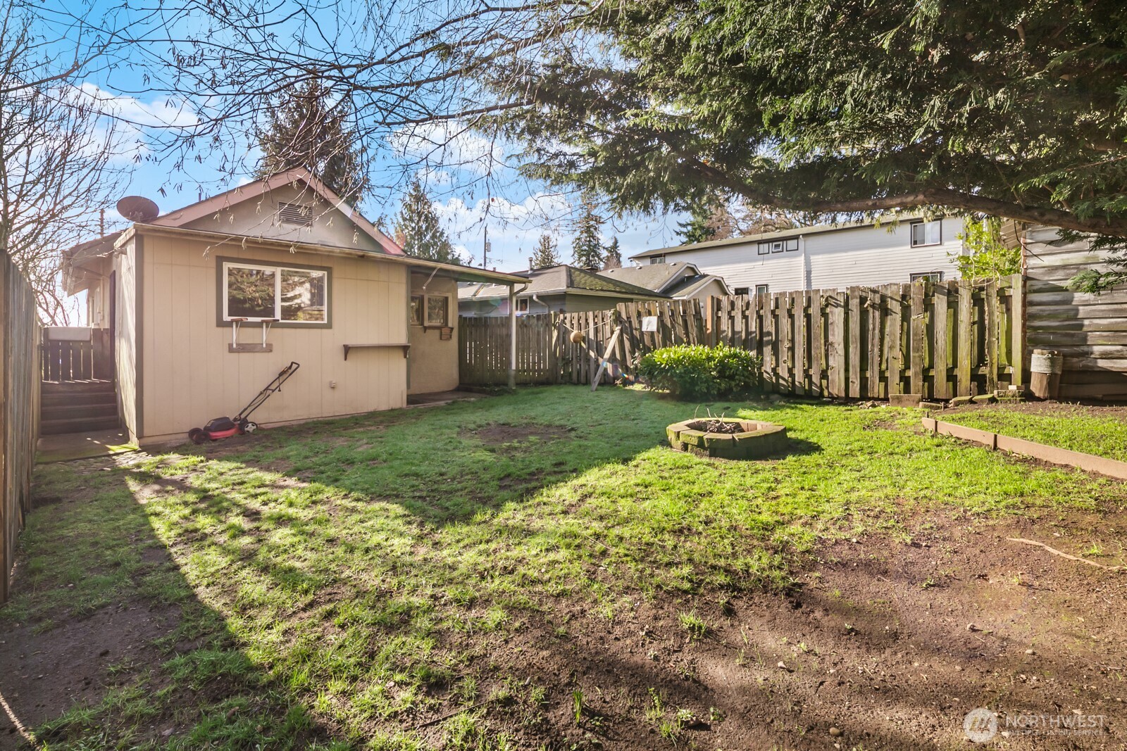 946 North 86th Street Seattle, WA 98103 - Photo 20 of 26 a view of a yard with wooden fence