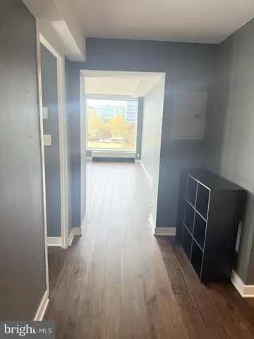 a view of empty room with wooden floor