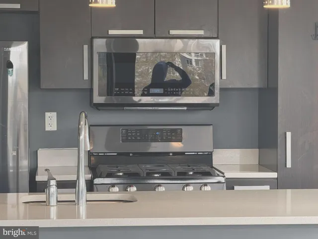 a white stove top oven sitting inside of a kitchen
