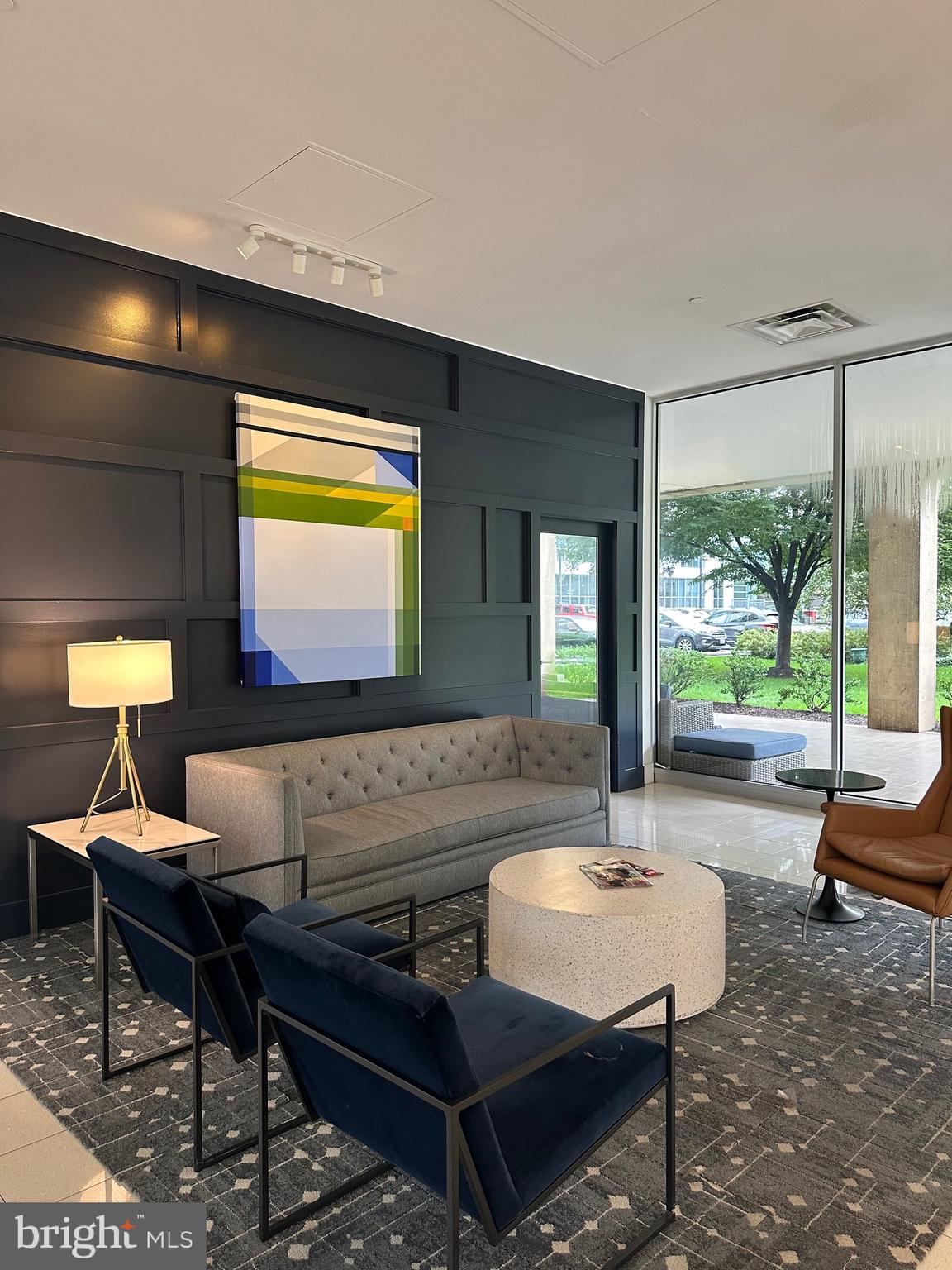 1101 3rd Street Southwest, Unit 306 Washington, DC 20024 - Photo 6 of 53 a living room with furniture and a large window