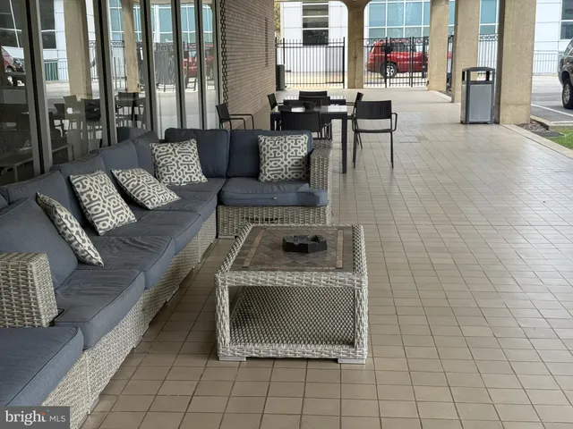 a living room with patio furniture and a fireplace