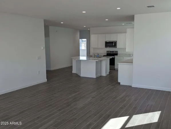a view of kitchen with cabinets microwave and stove