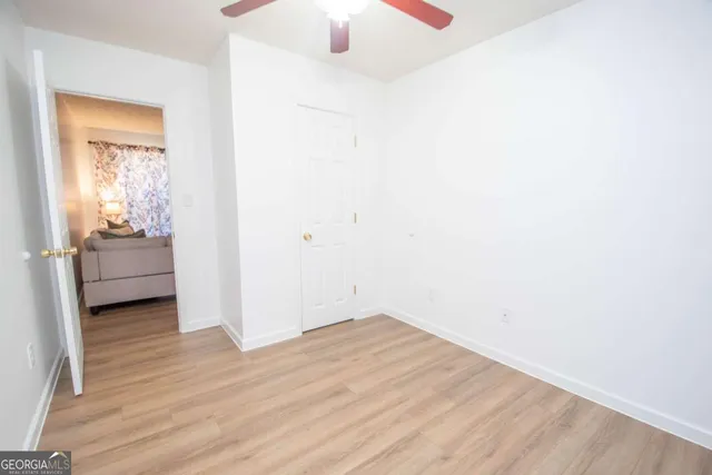 a view of a room with wooden floor and closet
