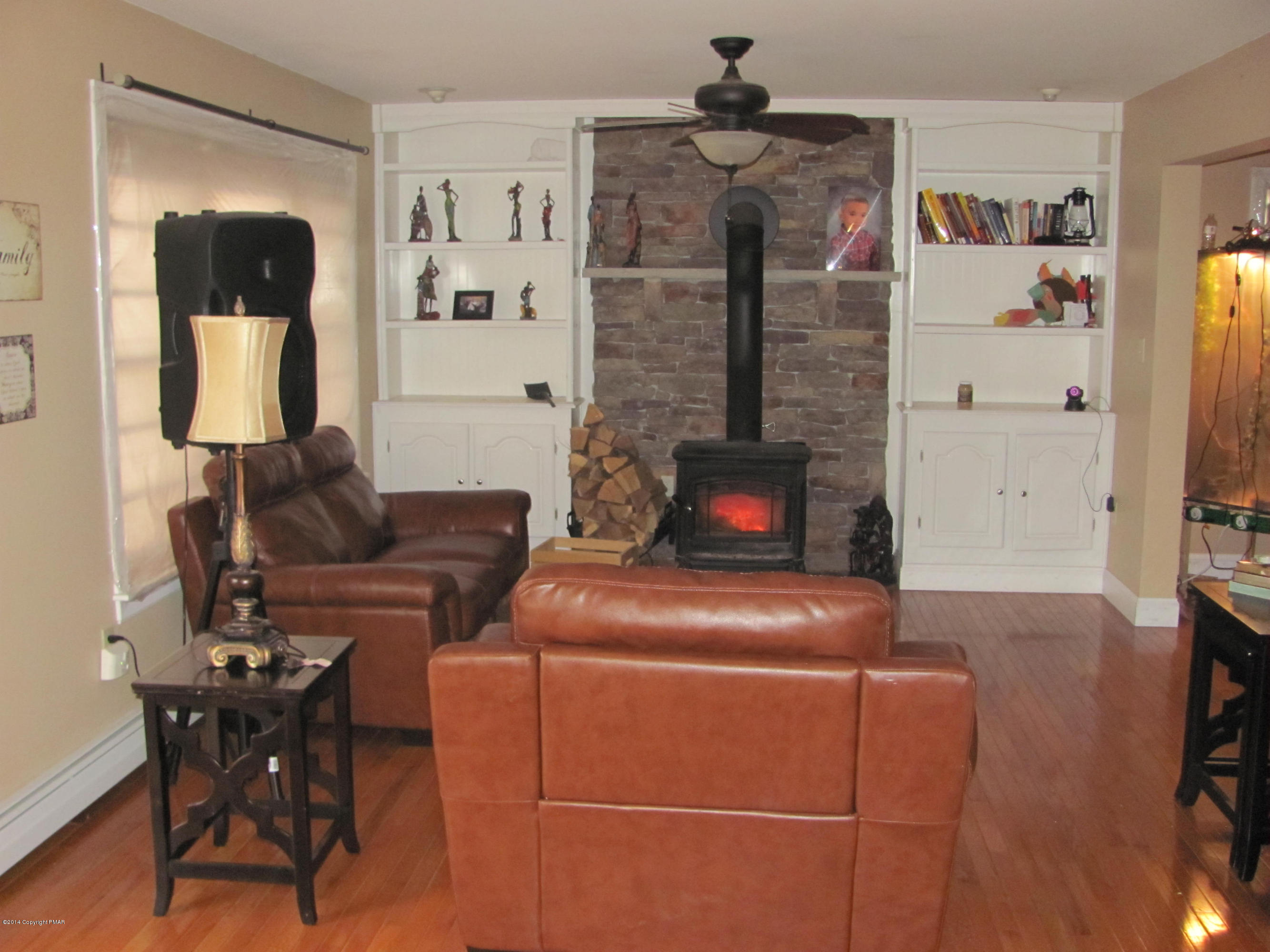 442 Henry's Crossing Road Cresco, PA 18326 - Photo 5 of 20 a living room with furniture and a fireplace