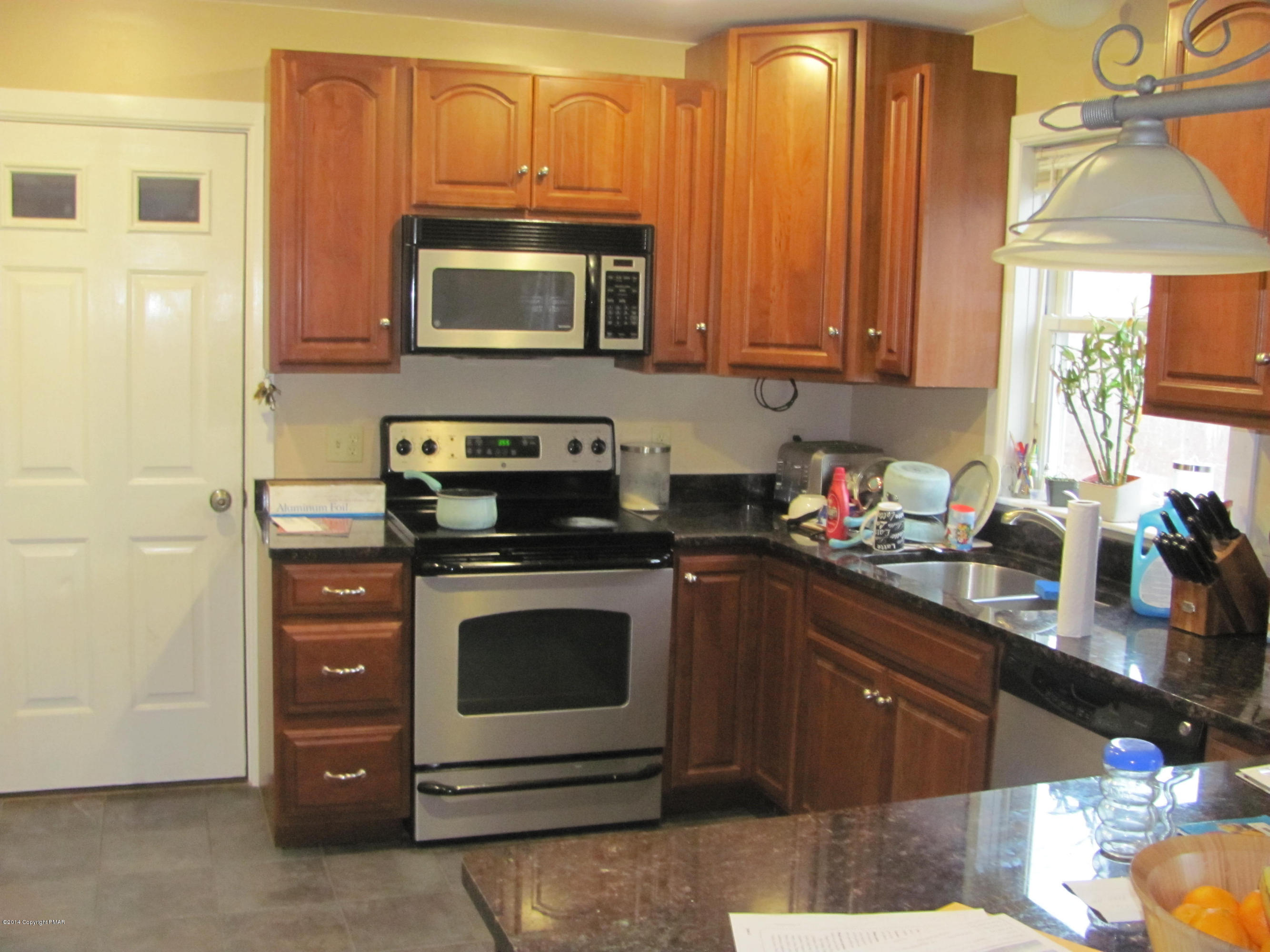 442 Henry's Crossing Road Cresco, PA 18326 - Photo 7 of 20 a kitchen with a cabinets and appliances