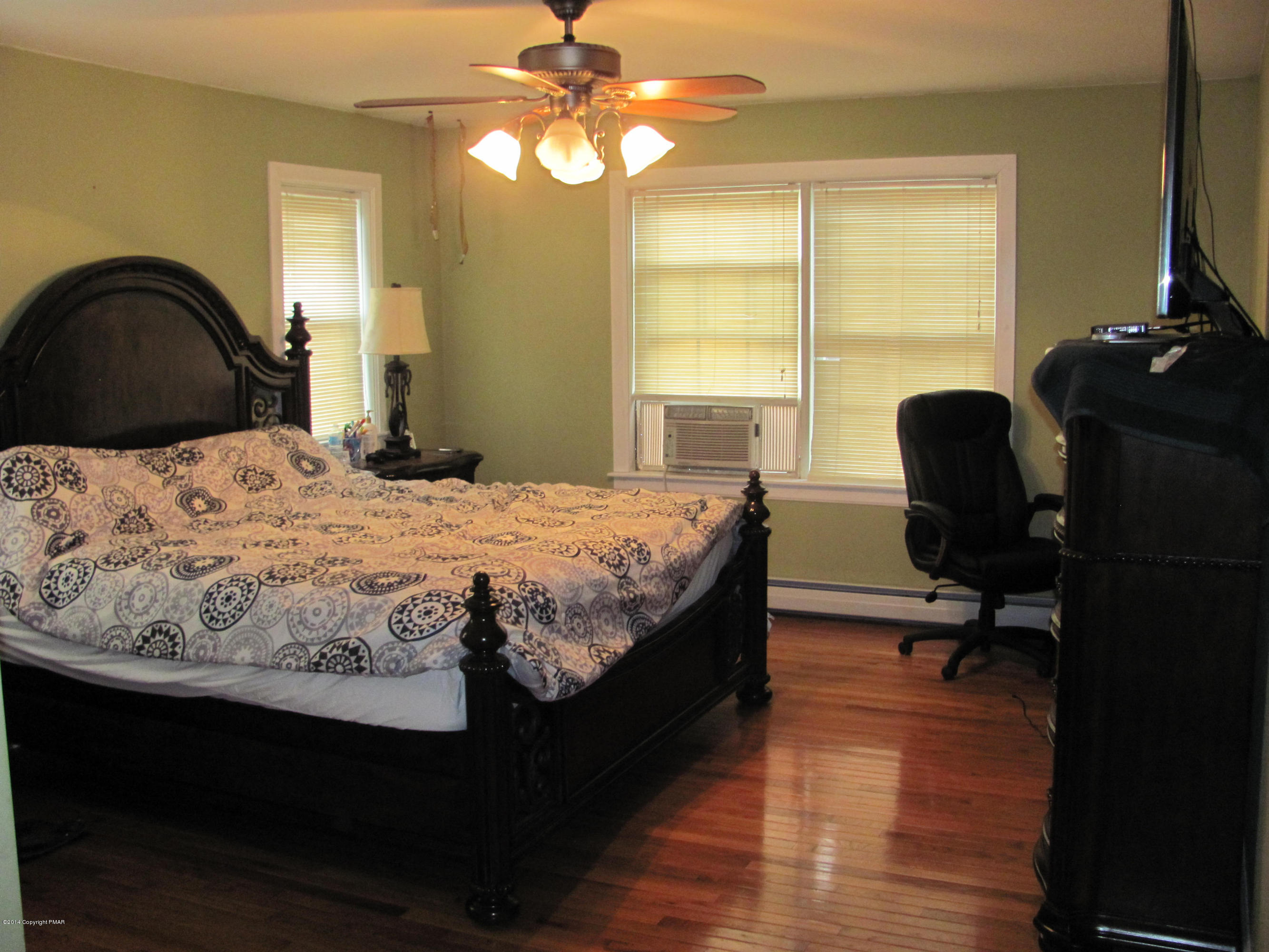 442 Henry's Crossing Road Cresco, PA 18326 - Photo 9 of 20 a bedroom with a bed and a chair