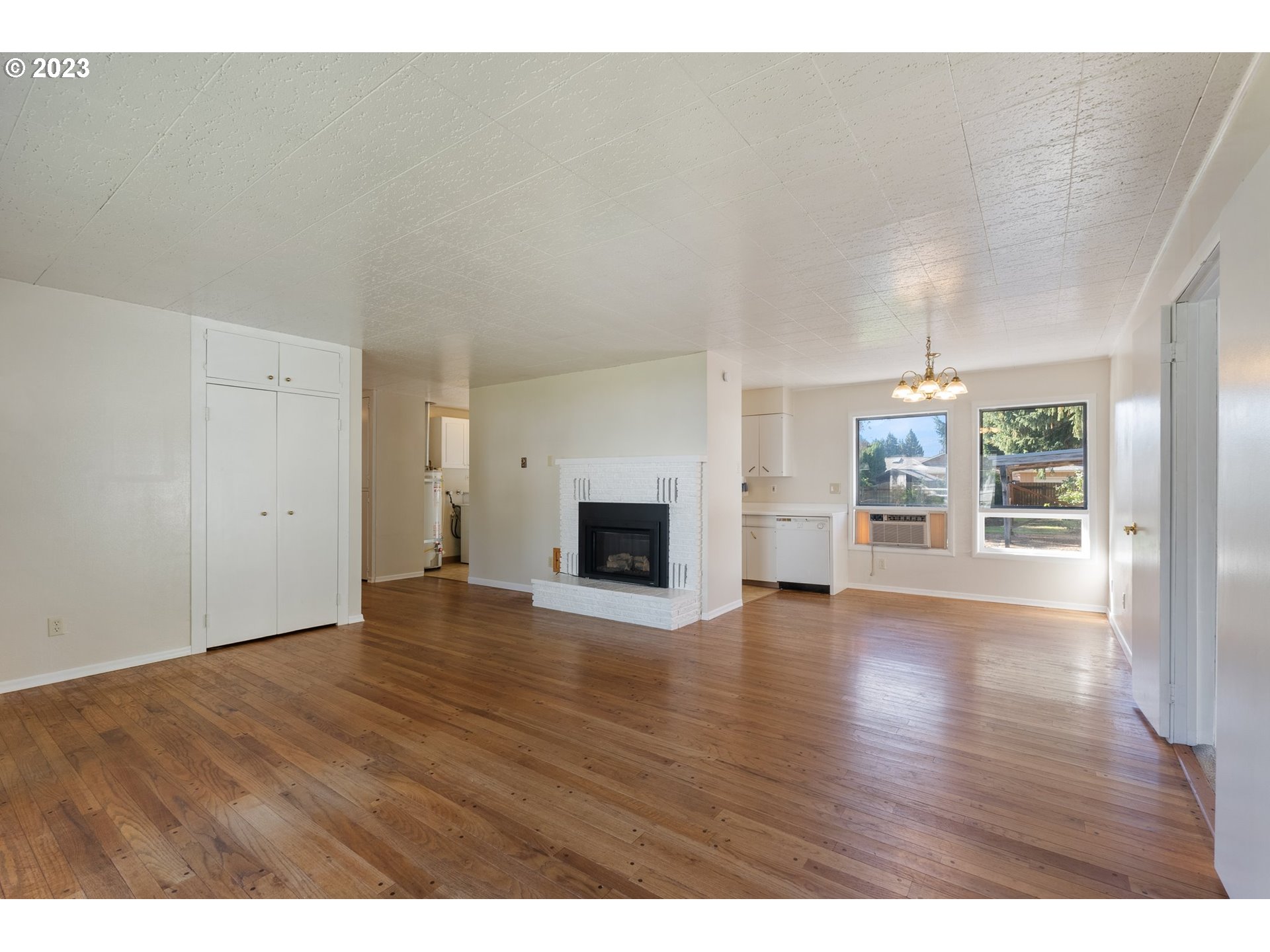 477 Northwest Chesser Road Stevenson, WA 98648 - Photo 12 of 40 a view of empty room with wooden floor and fireplace