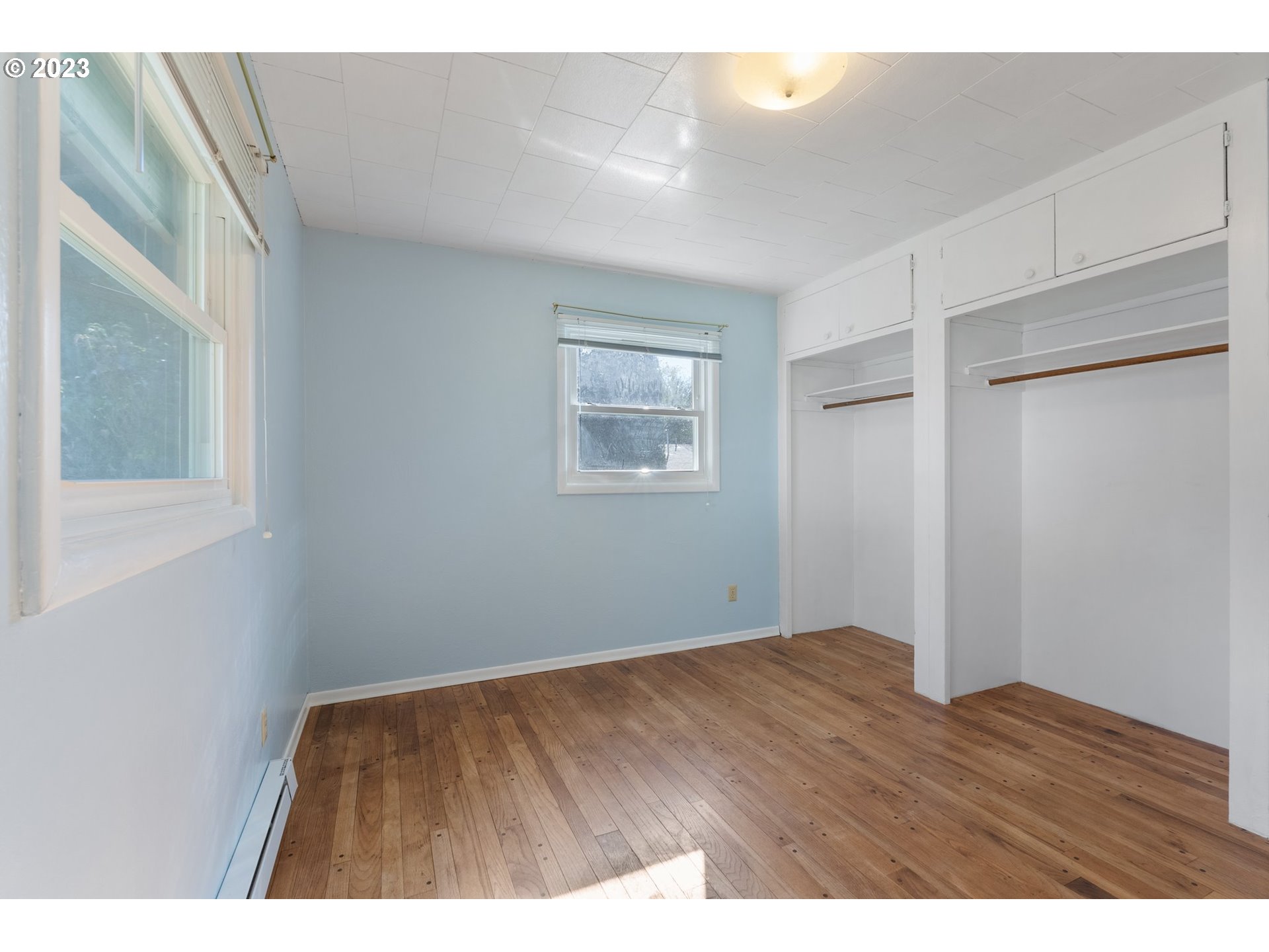477 Northwest Chesser Road Stevenson, WA 98648 - Photo 21 of 40 a view of an empty room with wooden floor and a window