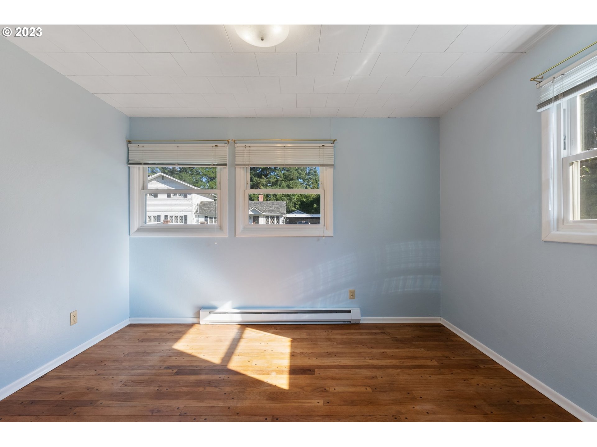 477 Northwest Chesser Road Stevenson, WA 98648 - Photo 23 of 40 an empty room with wooden floor and windows