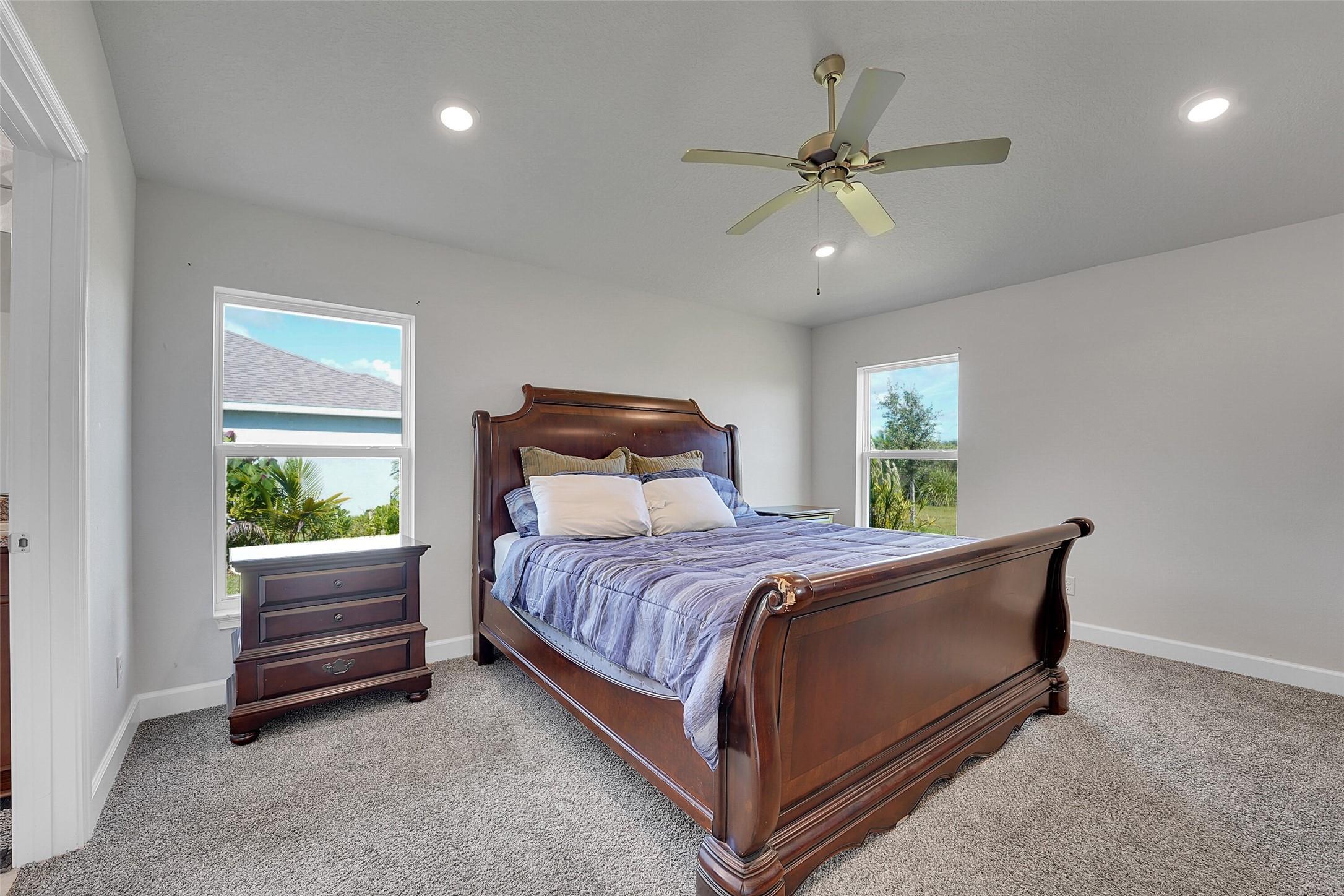8600 Merano Avenue Fort Pierce, FL 34951 - Photo 11 of 22 a bedroom with a bed and window