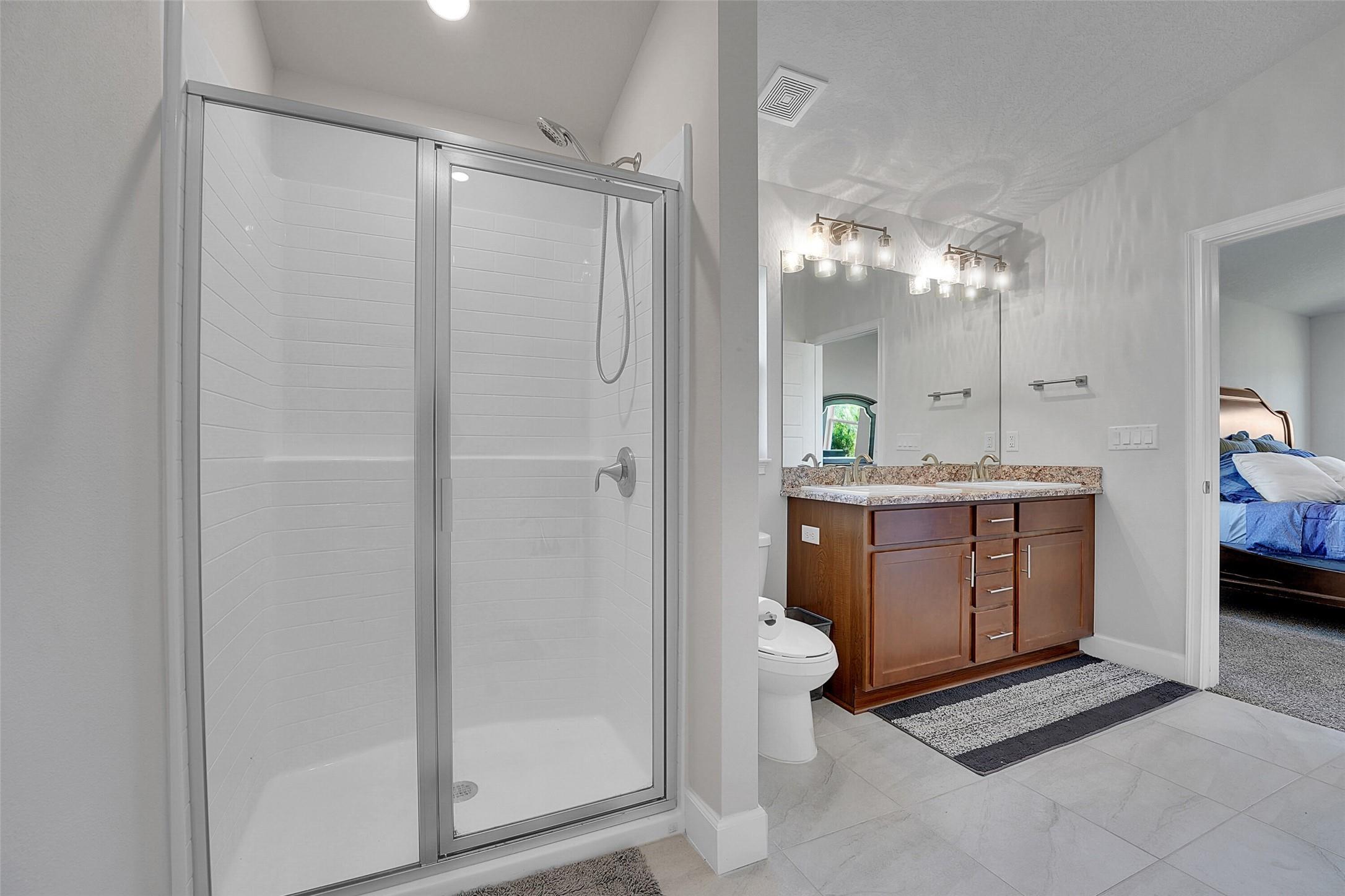 8600 Merano Avenue Fort Pierce, FL 34951 - Photo 14 of 22 a spacious bathroom with a double vanity sink and a mirror