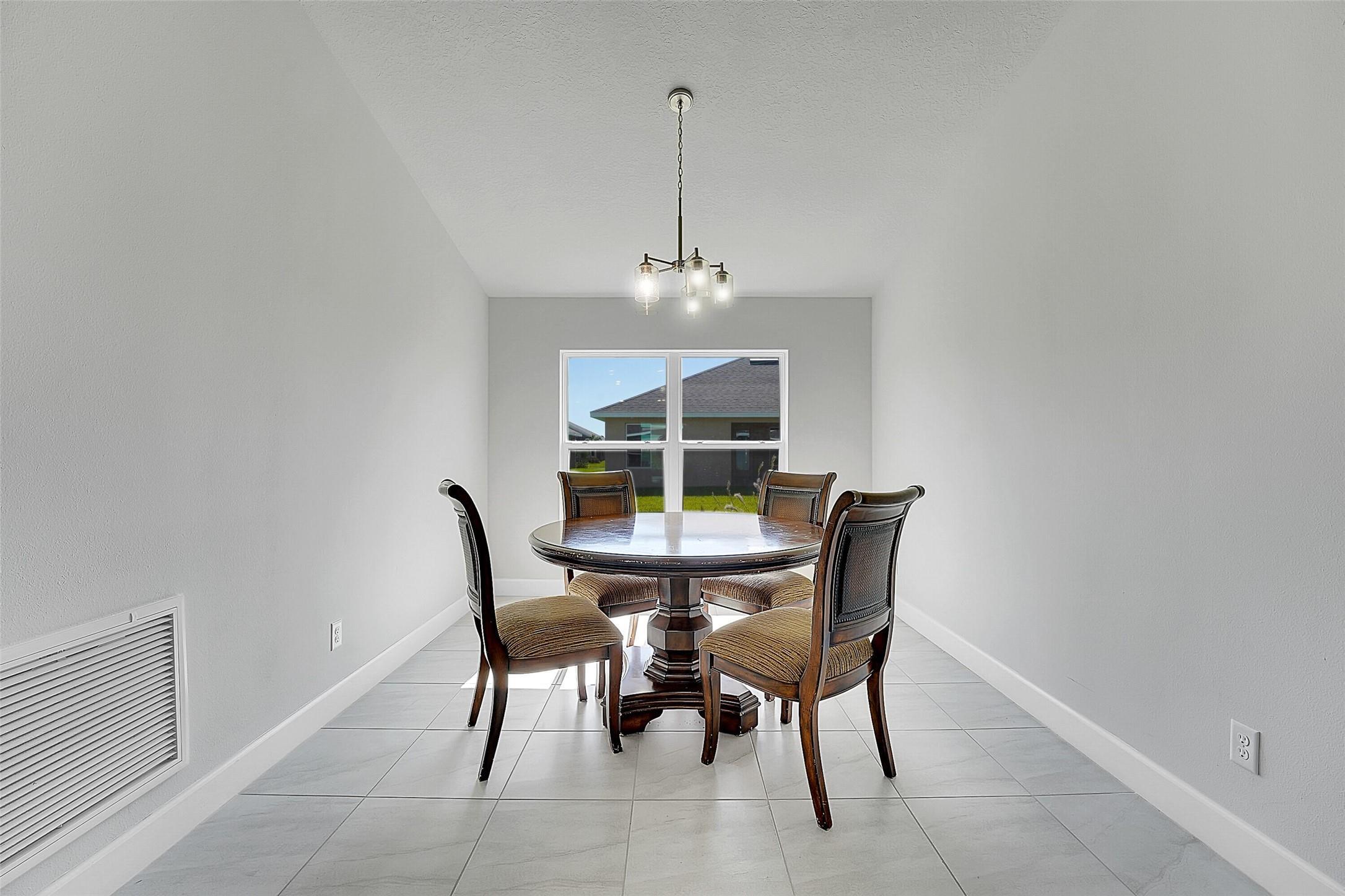 8600 Merano Avenue Fort Pierce, FL 34951 - Photo 3 of 22 a dining room with furniture and window