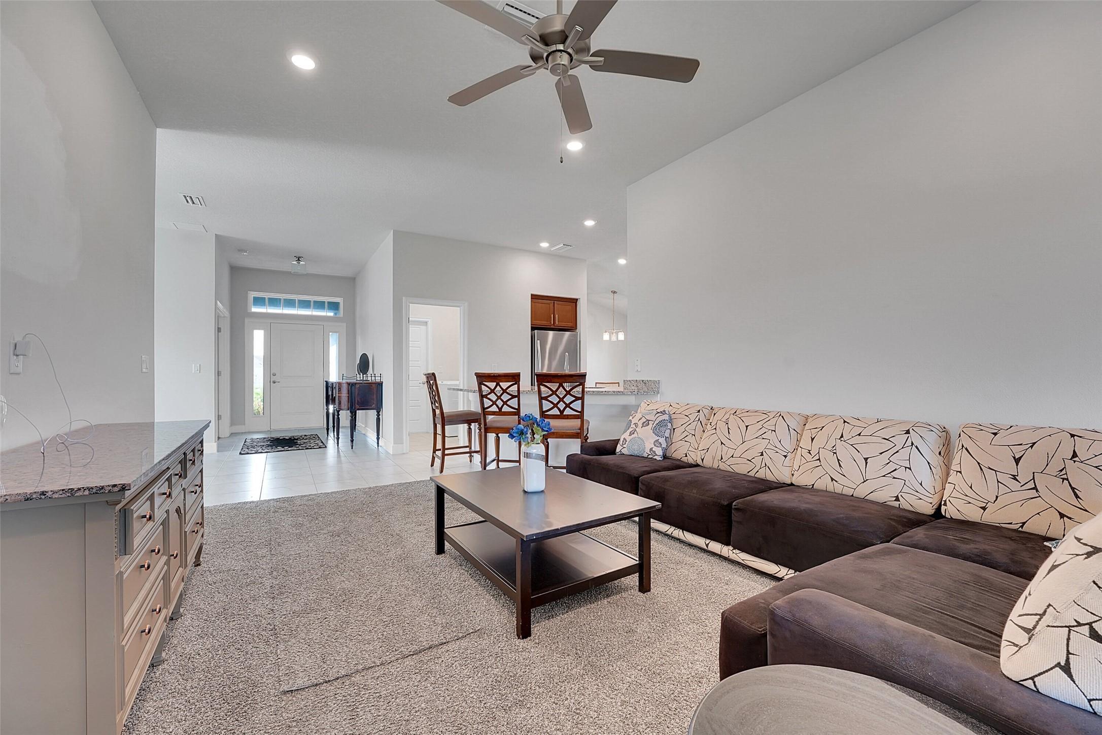 8600 Merano Avenue Fort Pierce, FL 34951 - Photo 4 of 22 a living room with furniture and a chandelier