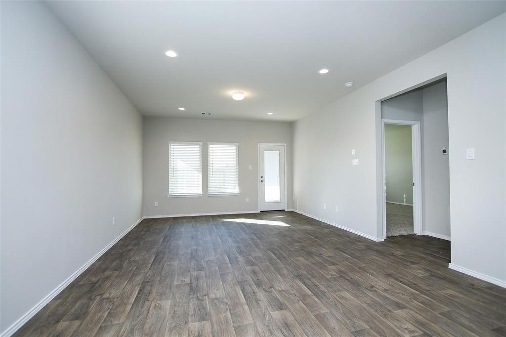 4023 Wyanngate Drive Spring, TX 77373 - Photo 15 of 23 a view of an empty room with wooden floor and a window