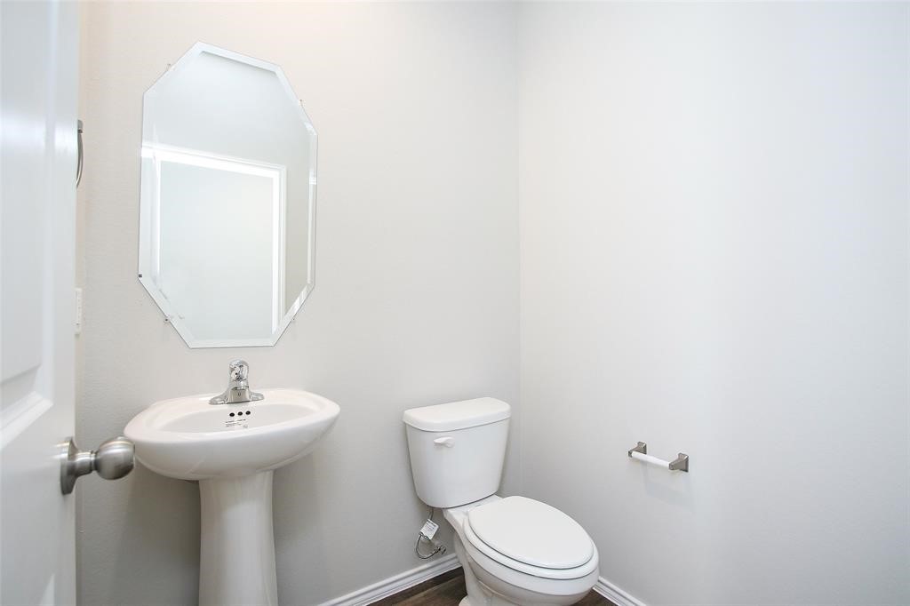 4023 Wyanngate Drive Spring, TX 77373 - Photo 5 of 23 a bathroom with a toilet sink and mirror