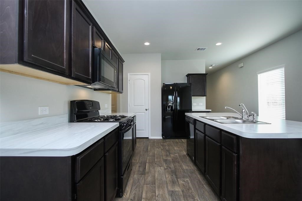 4023 Wyanngate Drive Spring, TX 77373 - Photo 8 of 23 a kitchen with stainless steel appliances granite countertop a sink stove and refrigerator