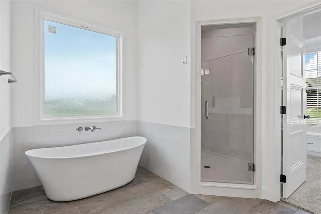 a white bath tub sitting next to a shower