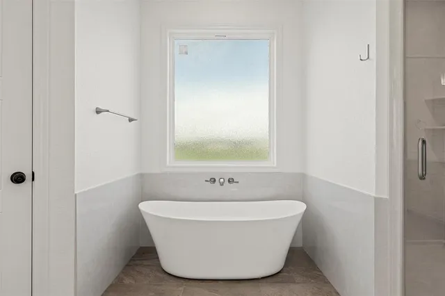 a white bath tub sitting in a bathroom