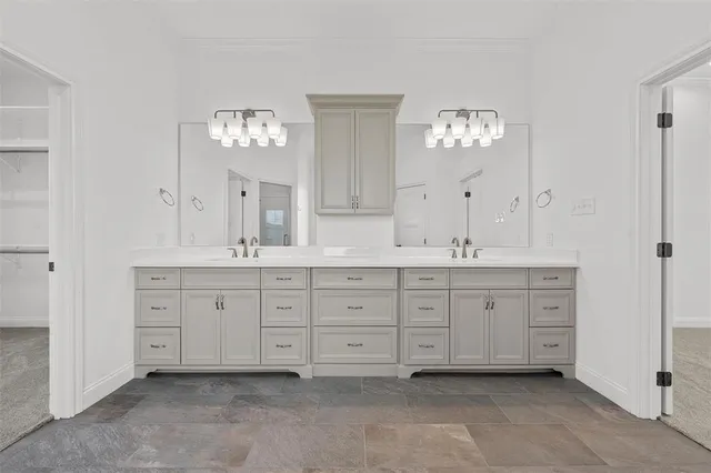 a spacious bathroom with double sink and a mirror