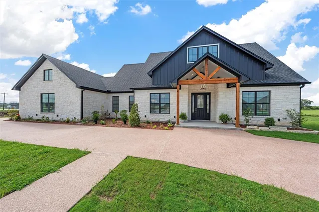 a front view of a house with a yard and porch