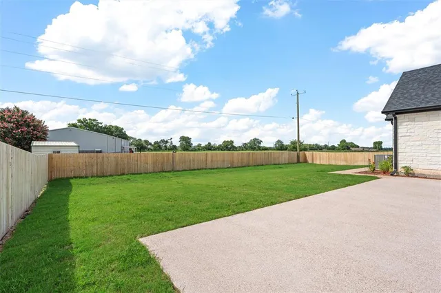 a view of a house with a yard and a garage