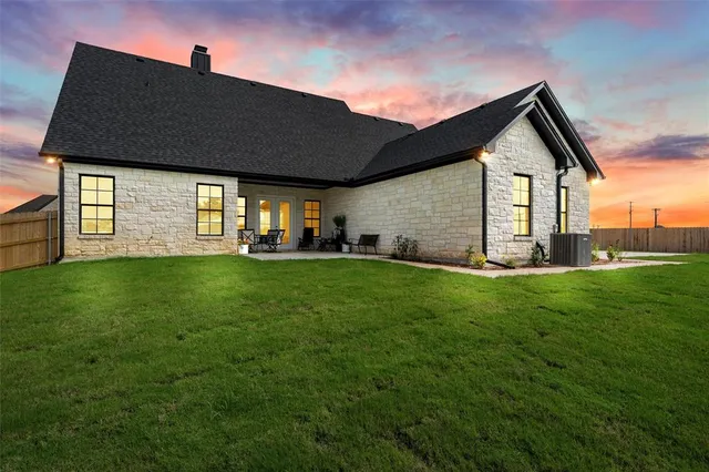 a front view of house with yard and green space