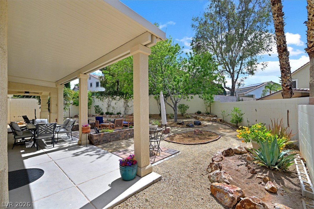 1259 Moon Vision Street Henderson, NV 89052 - Photo 36 of 53 An inviting covered patio opens to a low-maintenance desert-scaped yard, perfect for outdoor enjoyment.