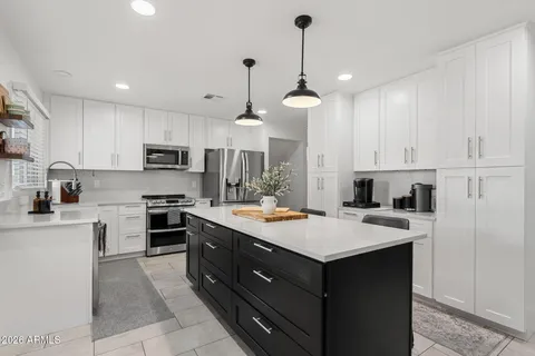 a kitchen with a stove sink and refrigerator