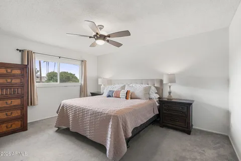 a bedroom with a bed and a window