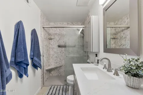 a bathroom with a sink toilet and shower
