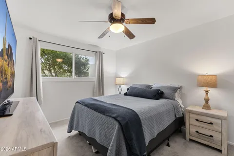 a bedroom with a bed and a chandelier