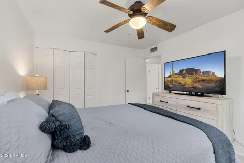 a bedroom with a bed and a flat screen tv