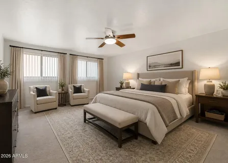 a bedroom with bed couch and window
