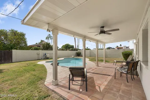 a patio with a table and chairs