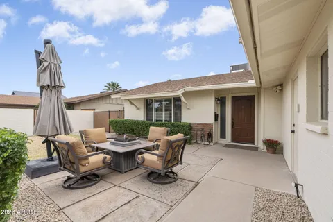 a view of a patio with table and chairs and potted plants